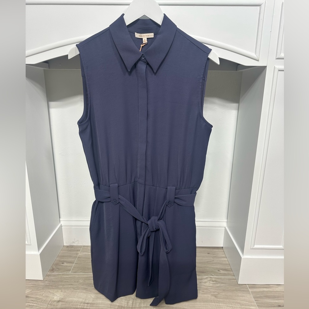 New with tags. Navy blue romper with belt. Recycled fabric. Skies are Blue